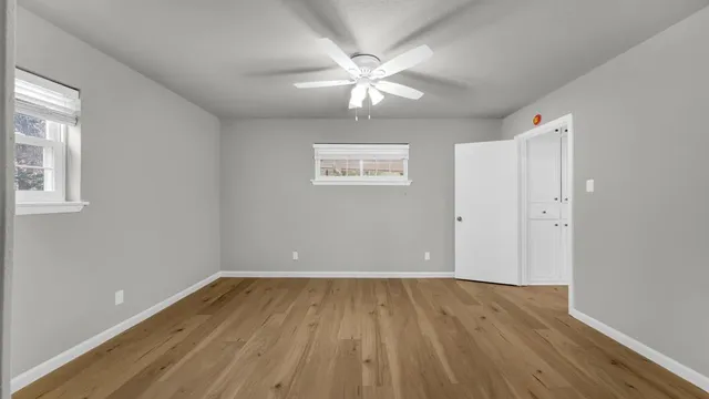 wooden floor in an empty room with a window