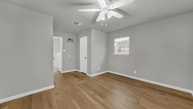 wooden floor in an empty room with a window