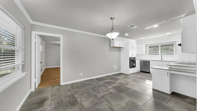 a view of a kitchen with a sink and dishwasher cabinets