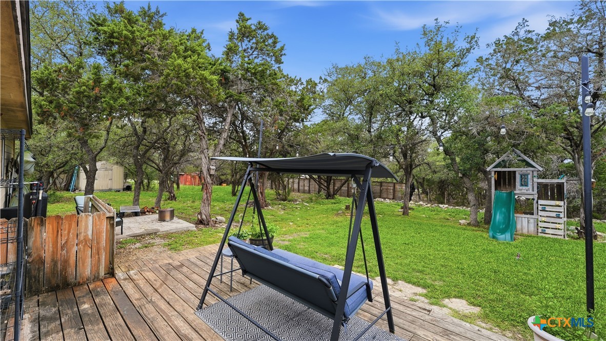 2216 Hornsby Spring Branch, TX 78070 - Photo 23 of 33 a view of backyard with a deck and a garden