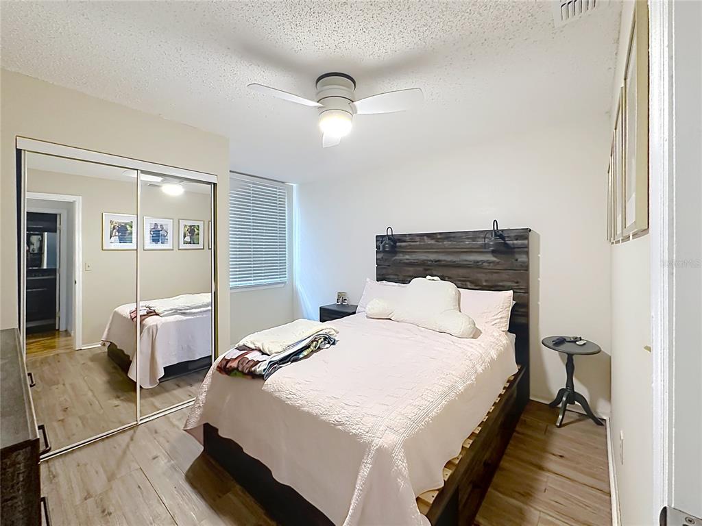 3705 Southwest 27th Street, Unit 922 Gainesville, FL 32608 - Photo 24 of 34 a bedroom with a bed and a chandelier