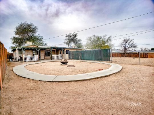 256 North Norma Street Ridgecrest, CA 93555 - Photo 32 of 35 a view of a swimming pool with a yard