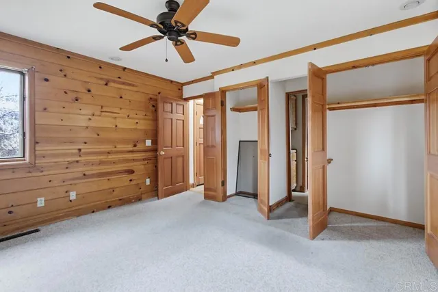a view of empty room with ceiling fan