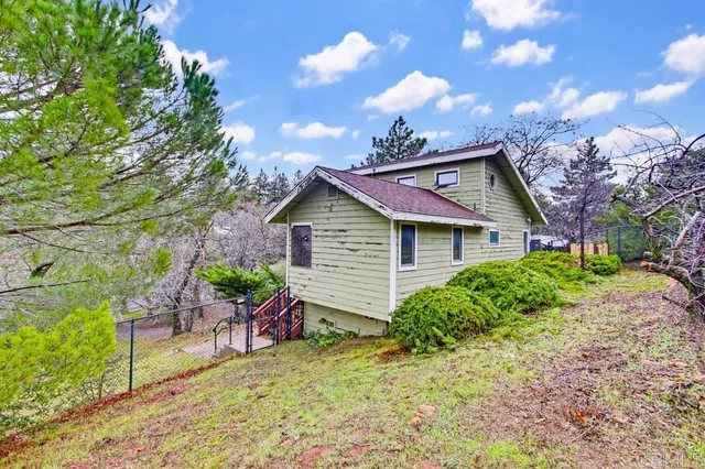 a view of house with backyard
