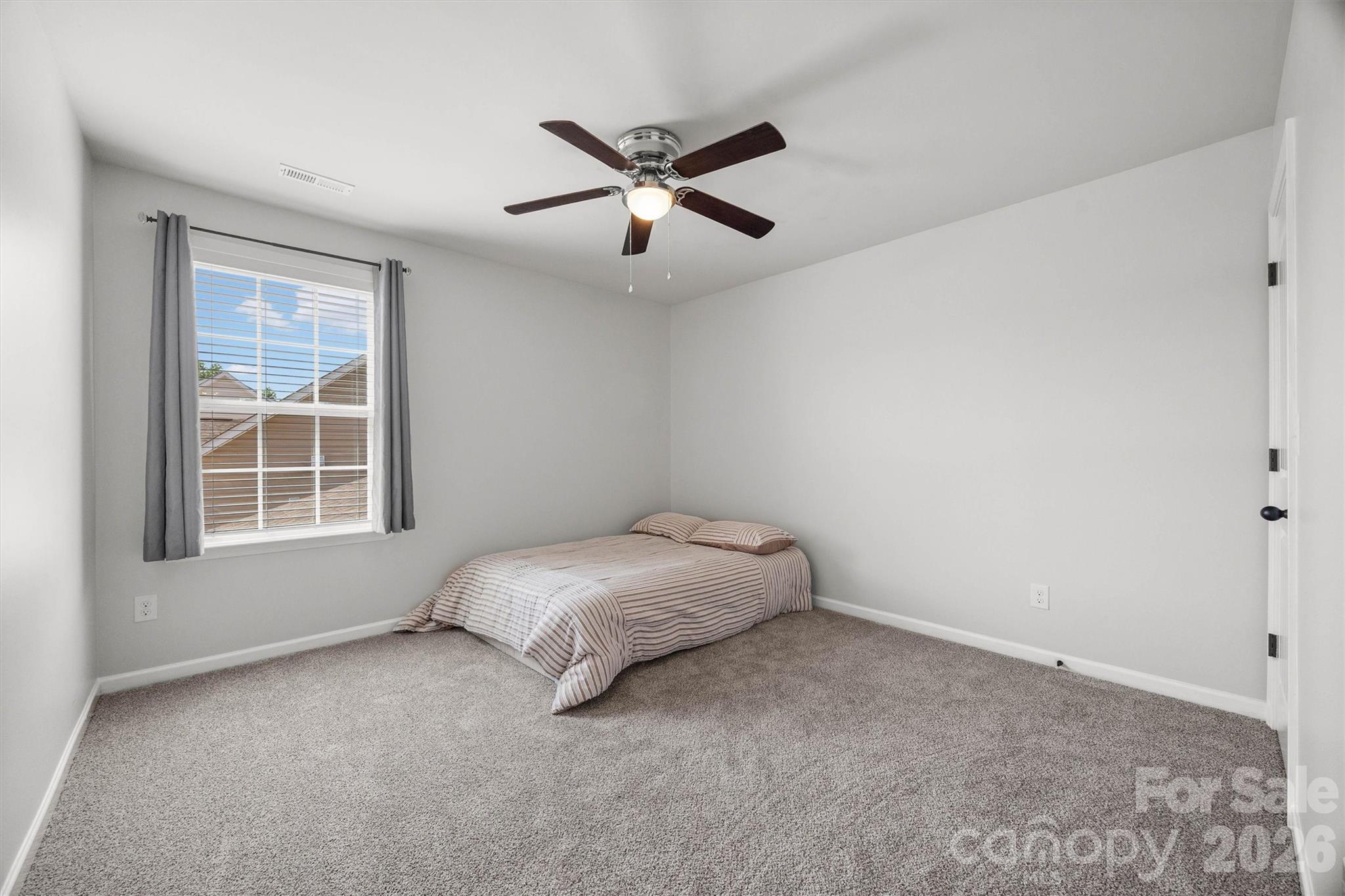 299 Annatto Way Tega Cay, SC 29708 - Photo 33 of 46 a bed room with a bed and a ceiling fan