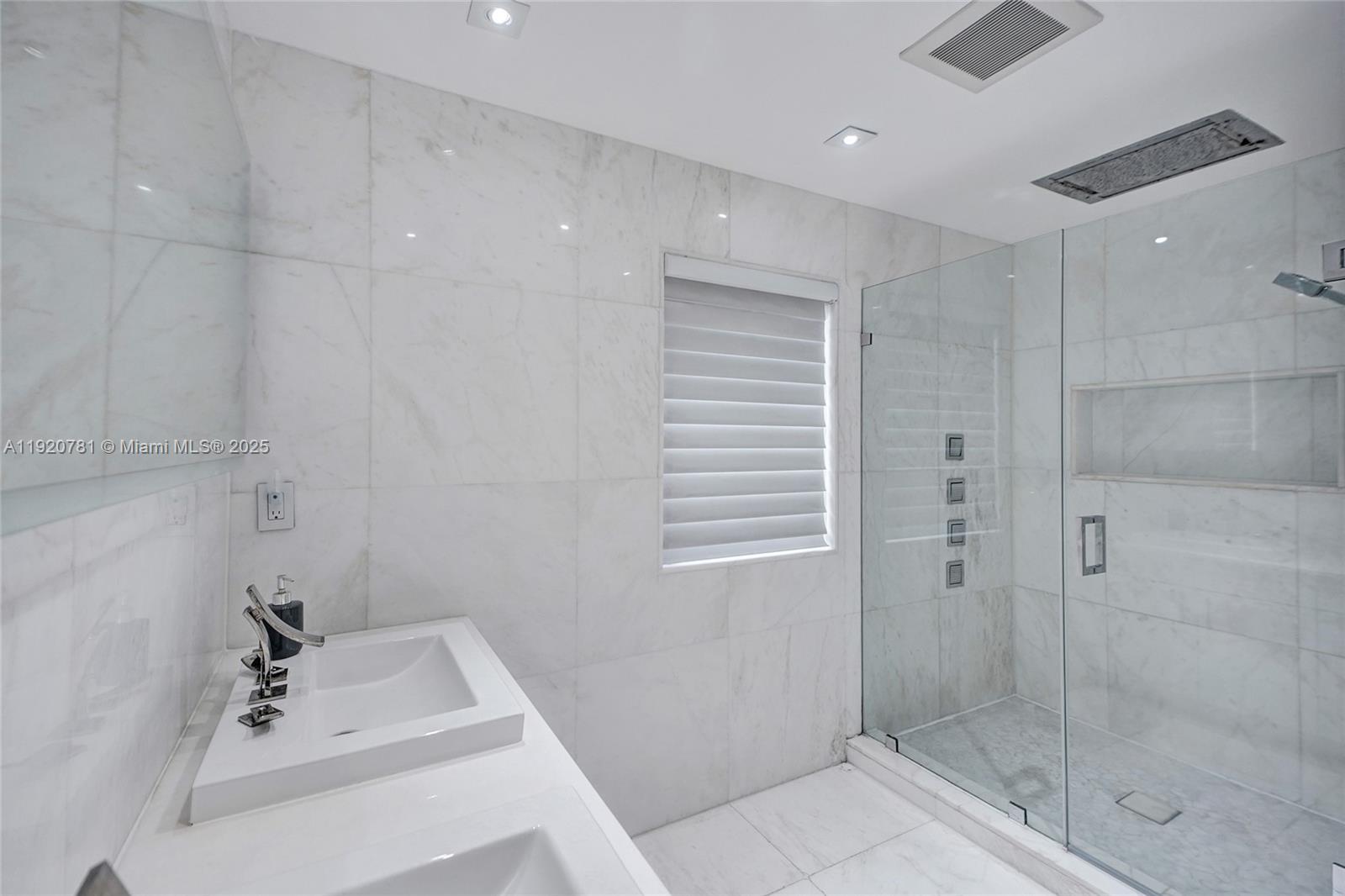 377 Northeast 194th Terrace Miami, FL 33179 - Photo 12 of 19 a bathroom with a sink a shower and a mirror