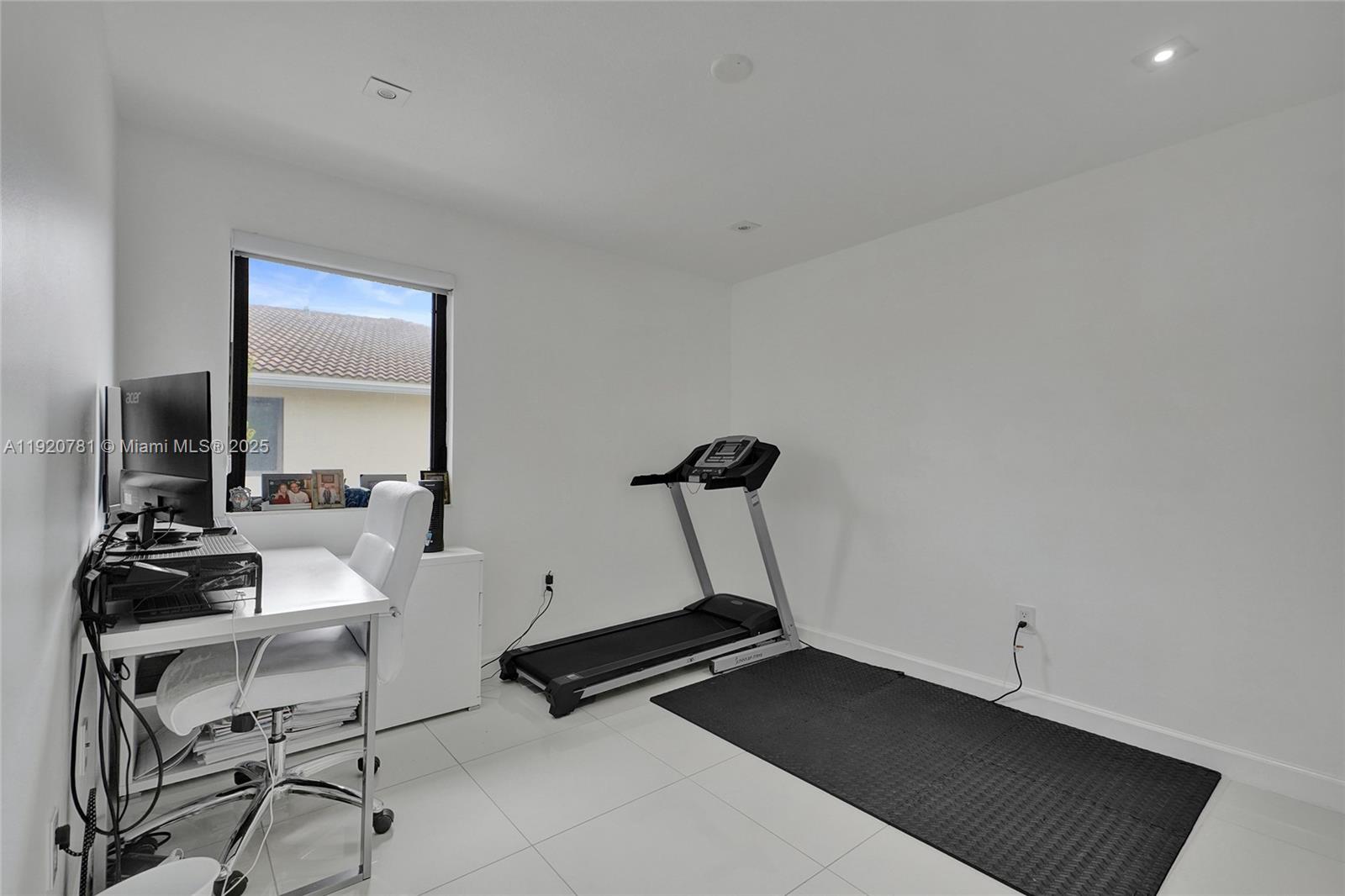 377 Northeast 194th Terrace Miami, FL 33179 - Photo 16 of 19 a room with gym equipment and a view of living room