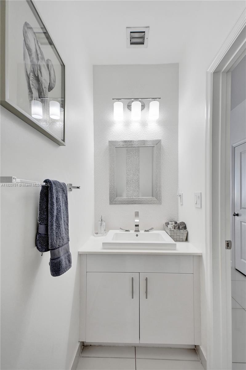 377 Northeast 194th Terrace Miami, FL 33179 - Photo 4 of 19 a bathroom with a sink and a mirror