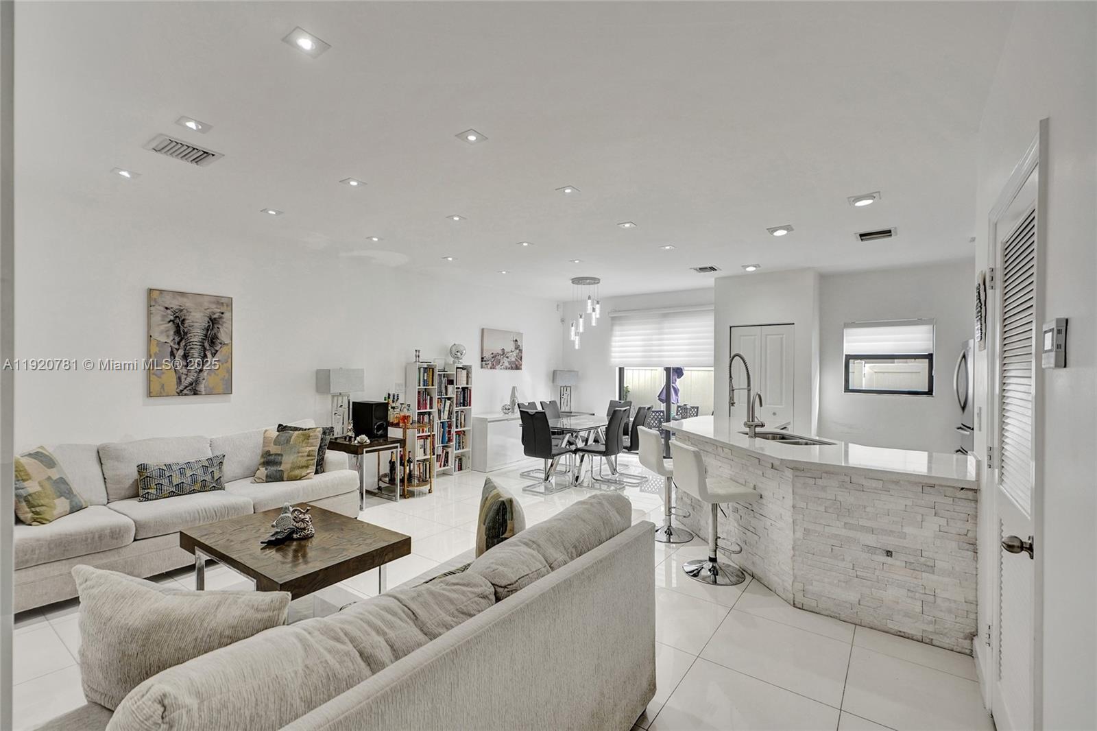 377 Northeast 194th Terrace Miami, FL 33179 - Photo 5 of 19 a living room with furniture and a table