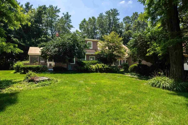 a view of a yard with large trees