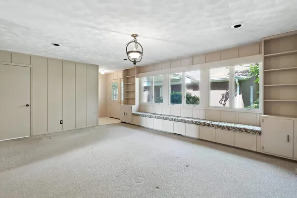 a view of an empty room with a window and balcony