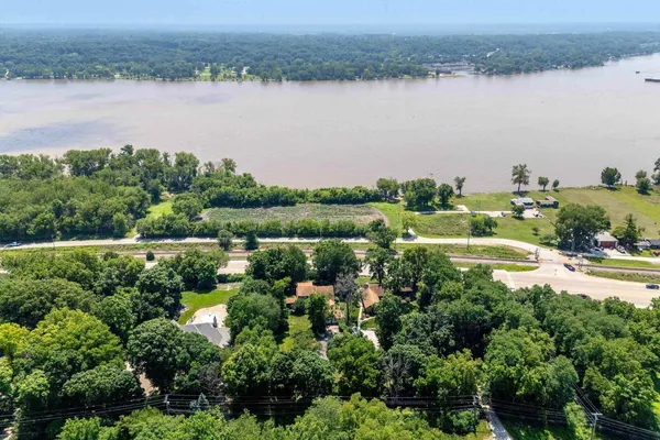an aerial view of residential house with outdoor space and trees all around