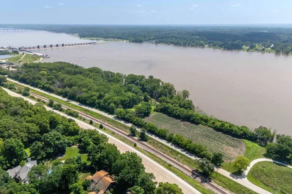 an aerial view of residential house with outdoor space and trees all around