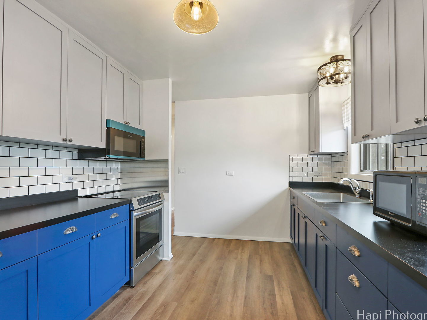 1291 Banbury Road Mundelein, IL 60060 - Photo 5 of 22 a kitchen with stainless steel appliances granite countertop a sink stove and microwave