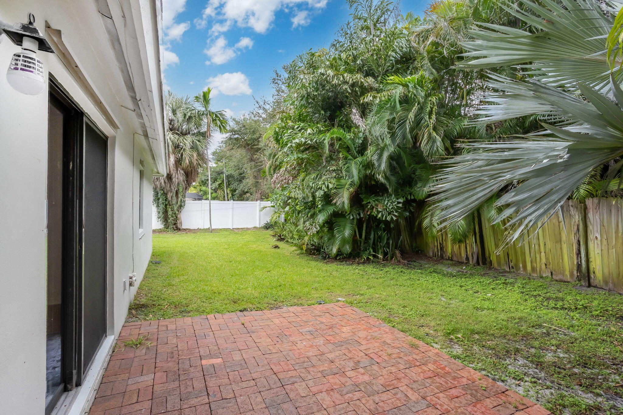 631 Bailey Street Boca Raton, FL 33487 - Photo 16 of 31 a view of backyard with potted plants and a palm tree
