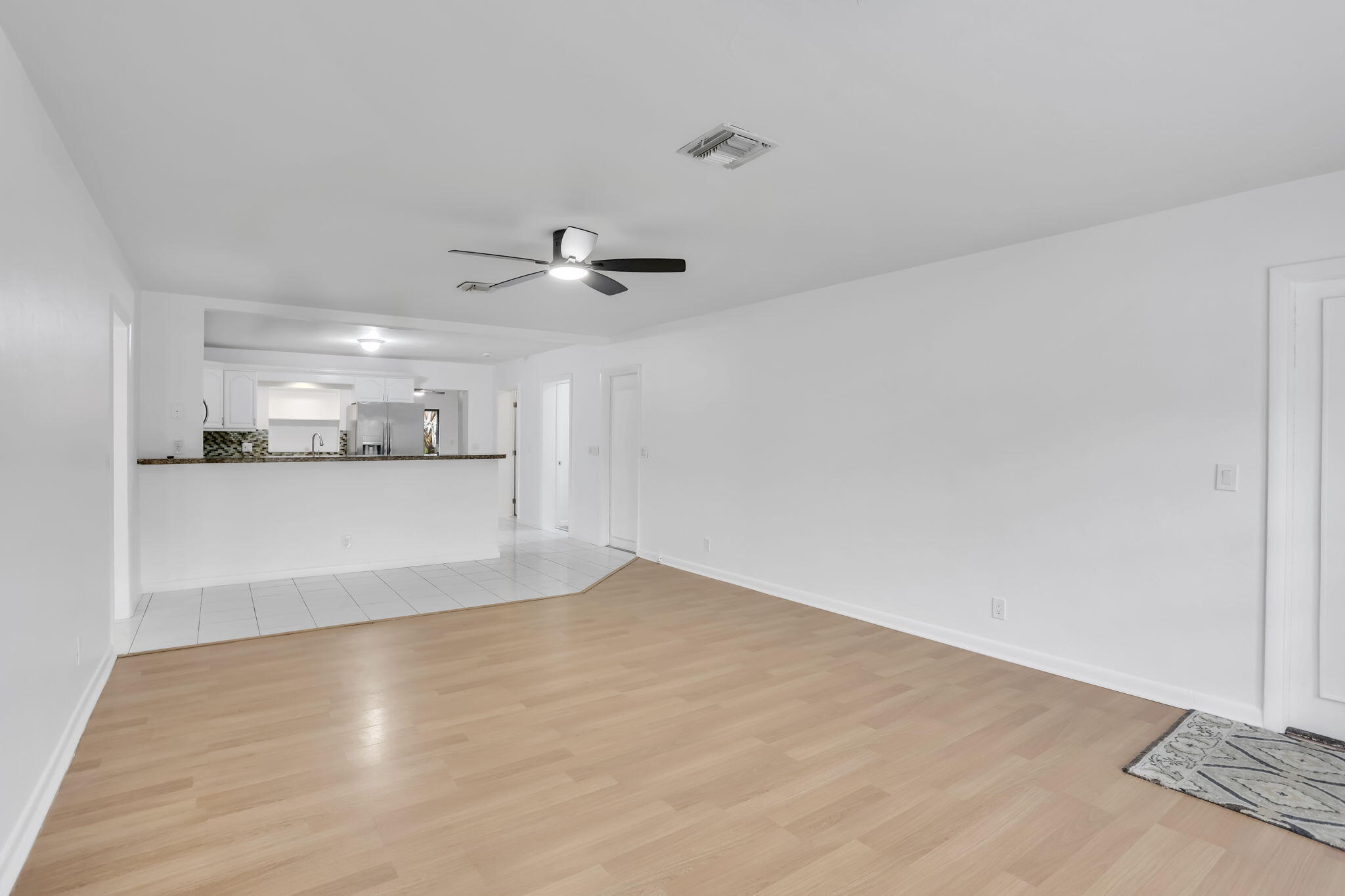 631 Bailey Street Boca Raton, FL 33487 - Photo 5 of 31 a view of a kitchen with a sink and a refrigerator