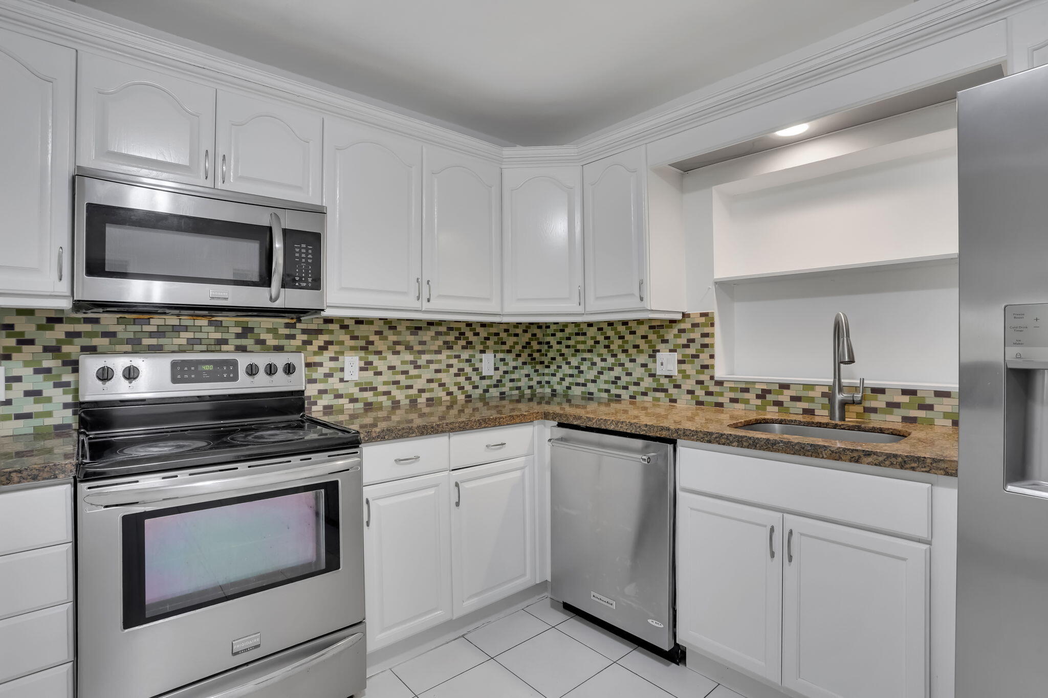 631 Bailey Street Boca Raton, FL 33487 - Photo 9 of 31 a kitchen with cabinets stainless steel appliances a sink and a stove