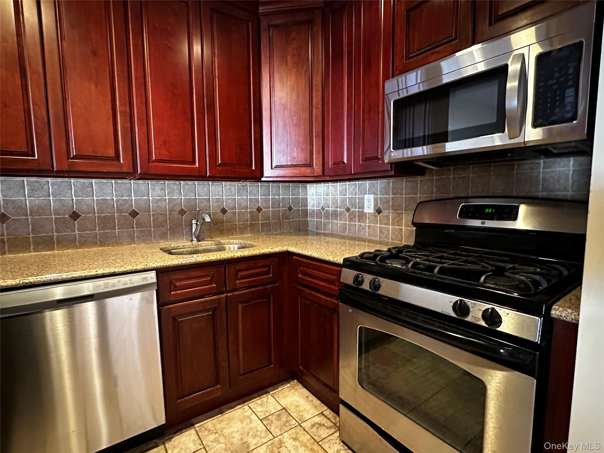 a kitchen with wooden cabinets and a stove top oven