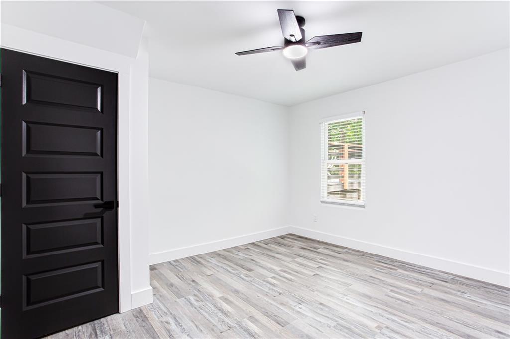 3038 Sutter Court Southwest Snellville, GA 30039 - Photo 13 of 22 a view of empty room with wooden floor and fan