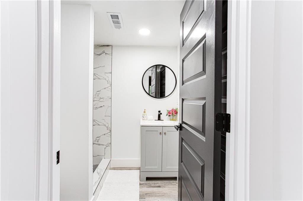 3038 Sutter Court Southwest Snellville, GA 30039 - Photo 15 of 22 a bathroom with a sink and a mirror