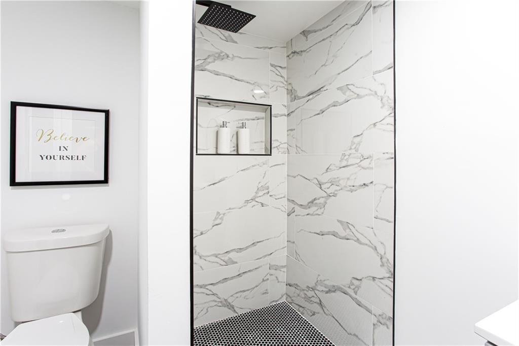 3038 Sutter Court Southwest Snellville, GA 30039 - Photo 16 of 22 a bathroom with a toilet and shower