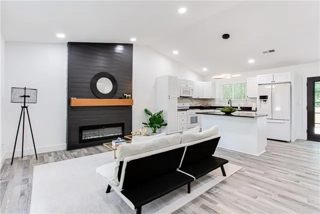 a living room with furniture and wooden floor