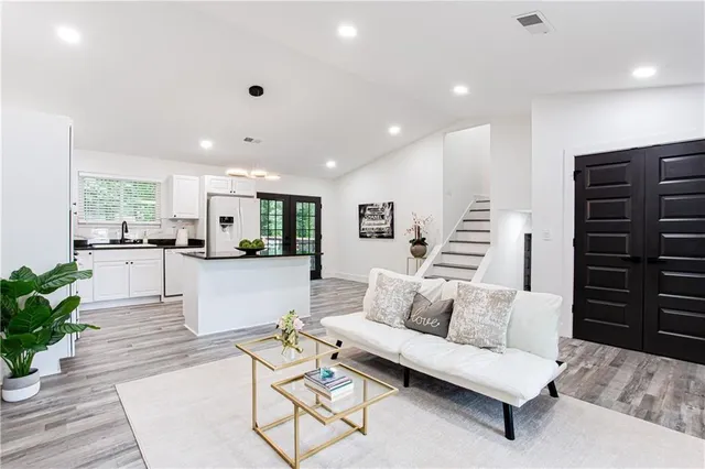a living room with furniture and flat screen tv