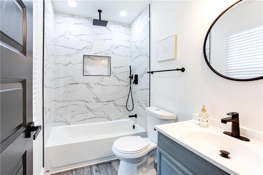 3038 Sutter Court Southwest Snellville, GA 30039 - Photo 8 of 22 a bathroom with a sink a toilet and a mirror