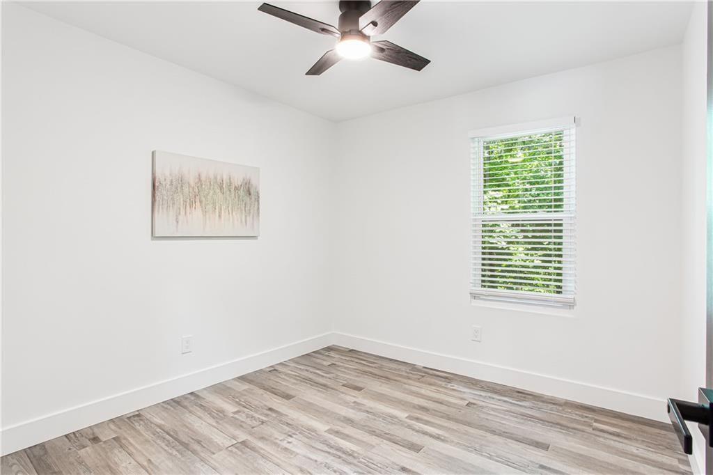 3038 Sutter Court Southwest Snellville, GA 30039 - Photo 9 of 22 a view of an empty room with wooden floor and a window