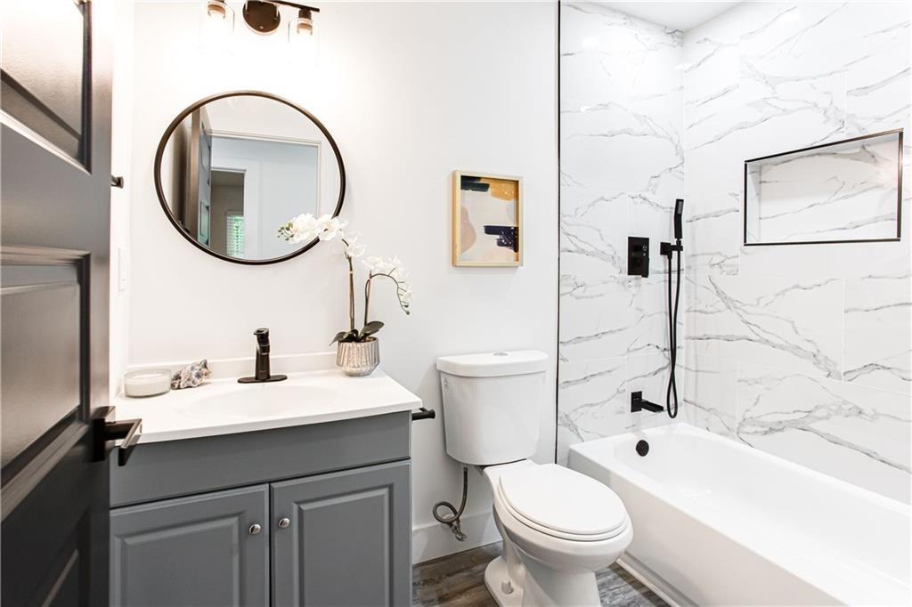 3038 Sutter Court Southwest Snellville, GA 30039 - Photo 10 of 22 a bathroom with a toilet sink and mirror