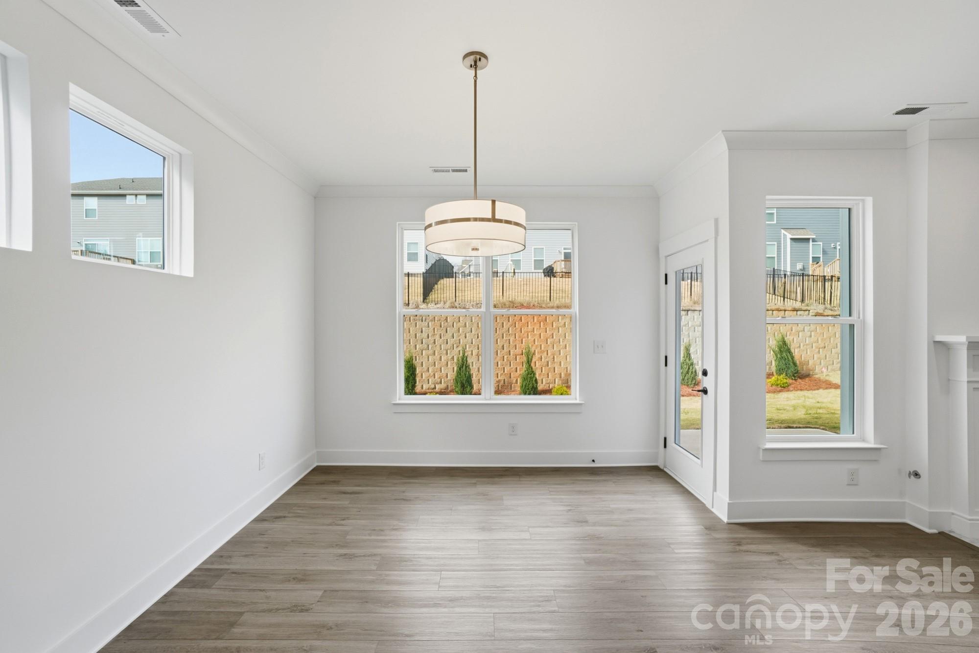 115 Longwood Road Mooresville, NC 28115 - Photo 14 of 43 an empty room with wooden floor and windows