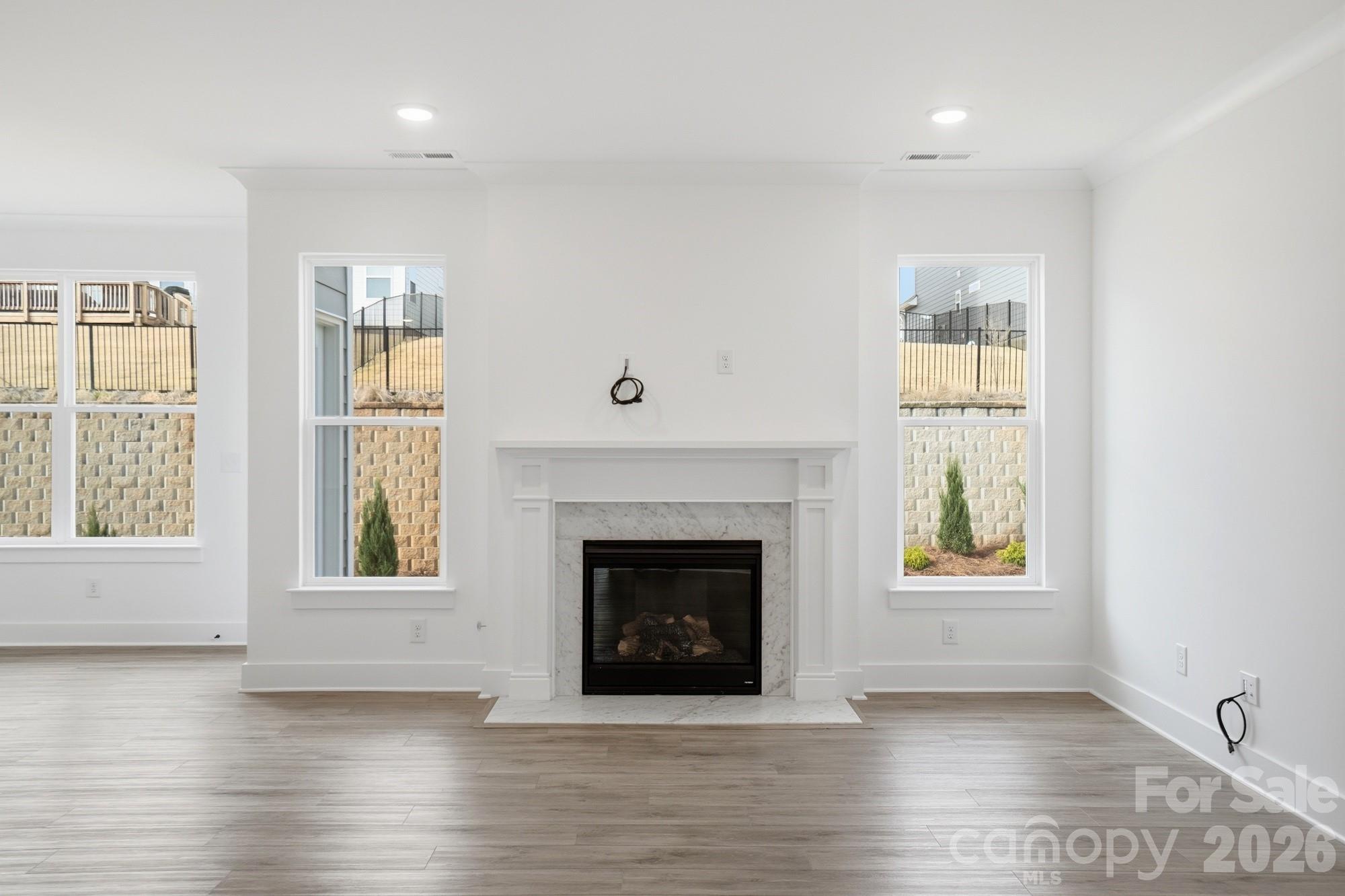 115 Longwood Road Mooresville, NC 28115 - Photo 17 of 43 an empty room with windows and fireplace