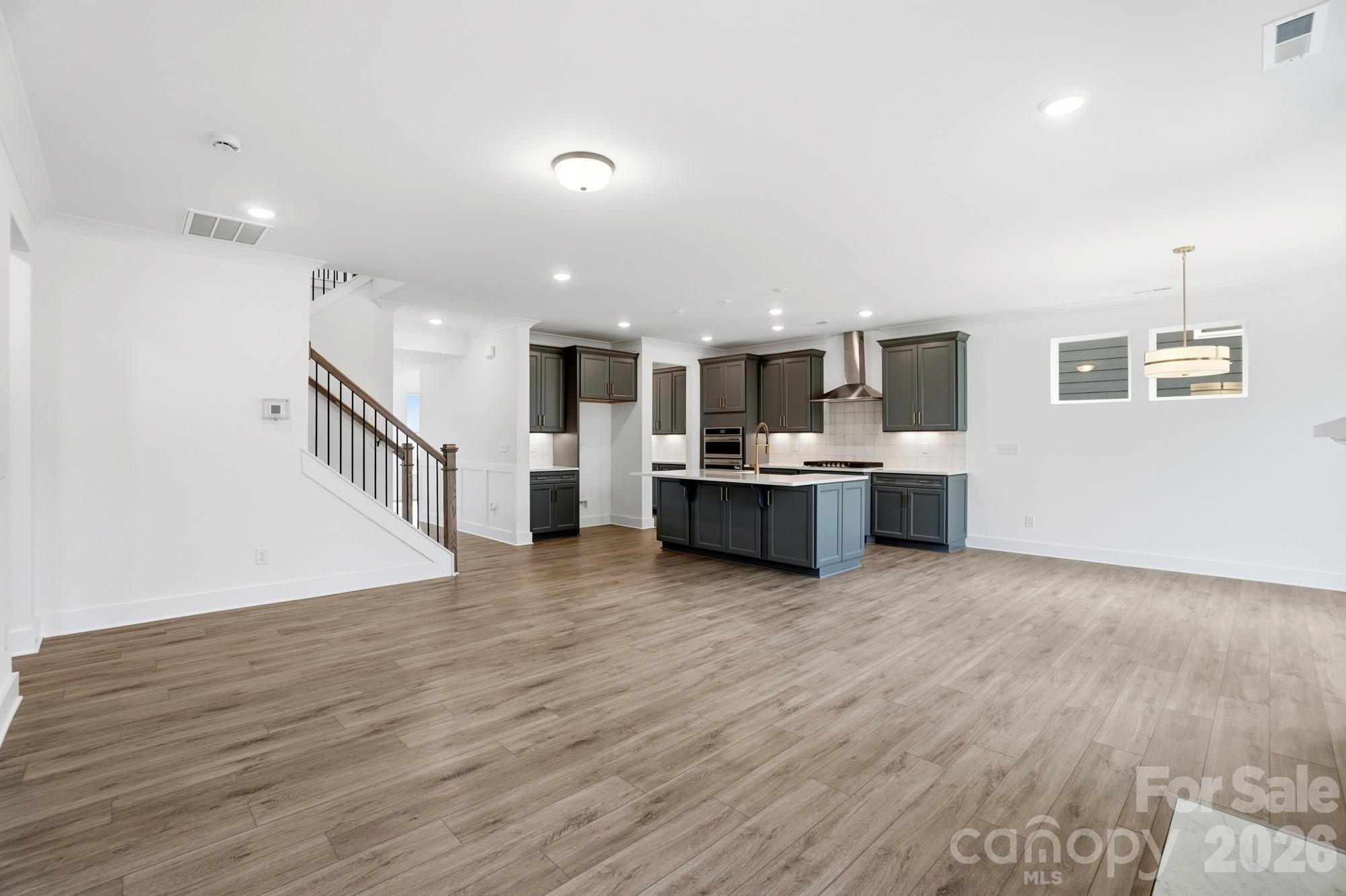 115 Longwood Road Mooresville, NC 28115 - Photo 18 of 43 a view of kitchen with cabinets and wooden floor