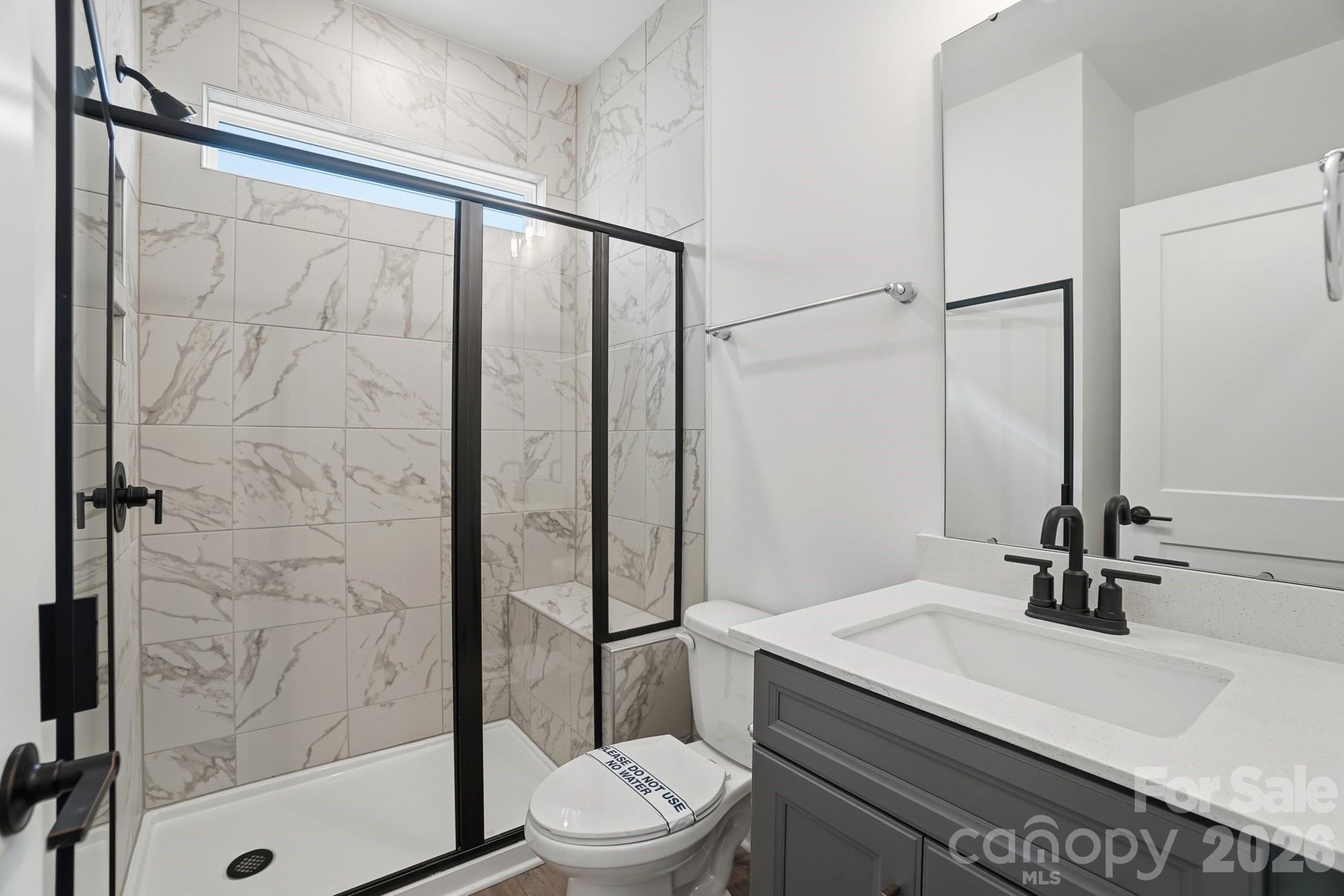 115 Longwood Road Mooresville, NC 28115 - Photo 22 of 43 a bathroom with a sink a toilet and shower