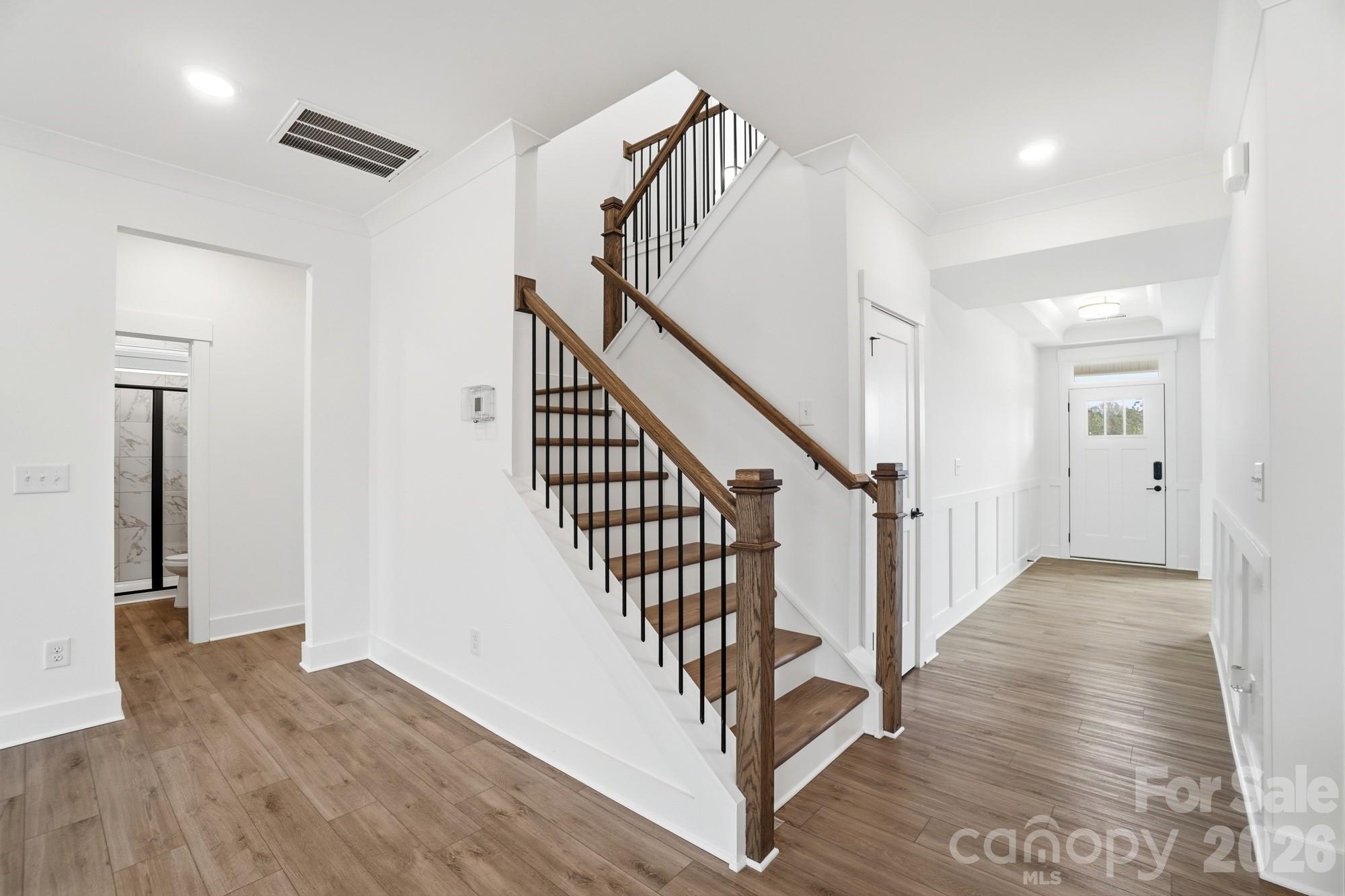 115 Longwood Road Mooresville, NC 28115 - Photo 24 of 43 a view of a hallway with wooden floor and stairs