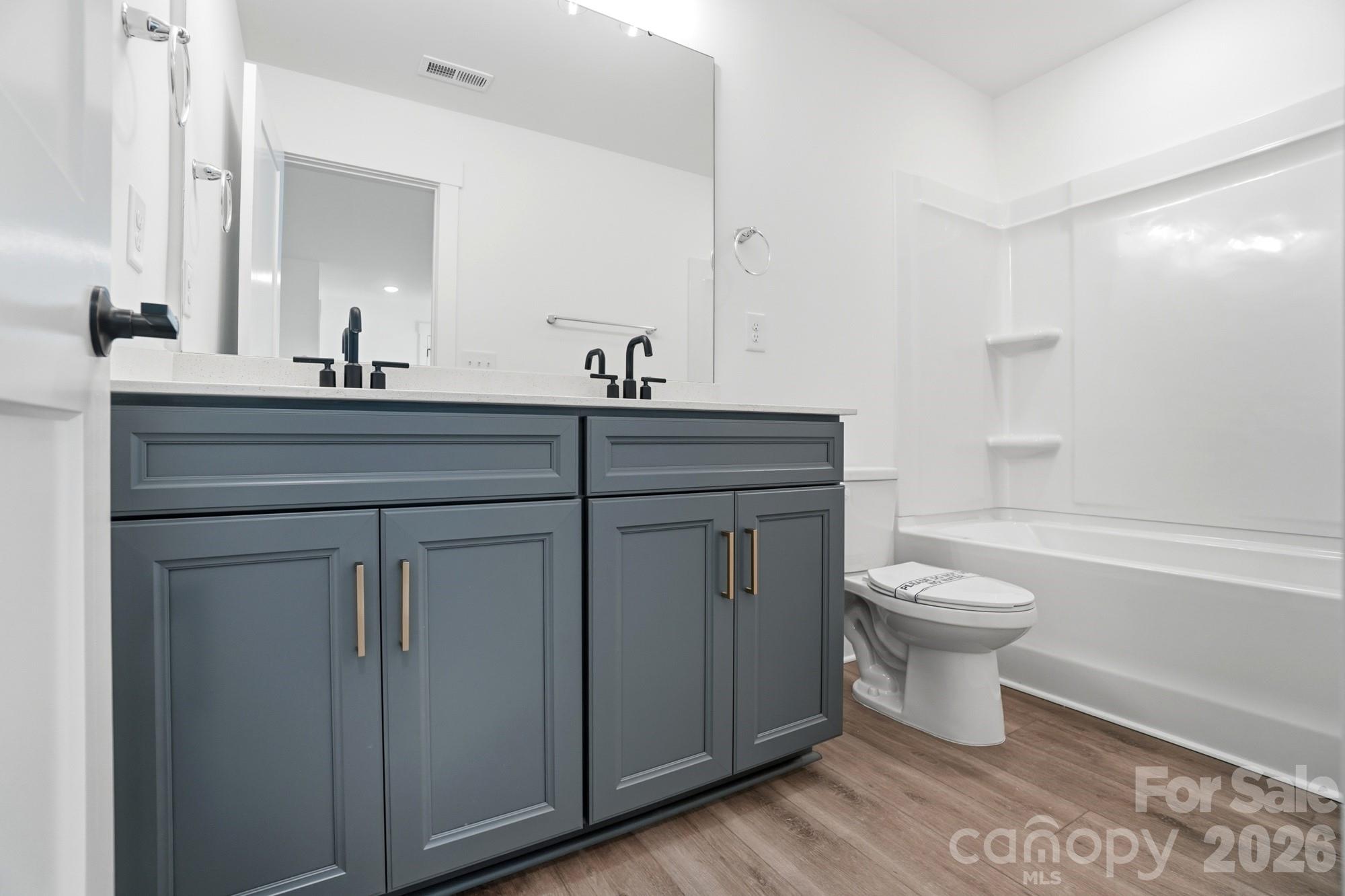 115 Longwood Road Mooresville, NC 28115 - Photo 37 of 43 a bathroom with a toilet sink and mirror