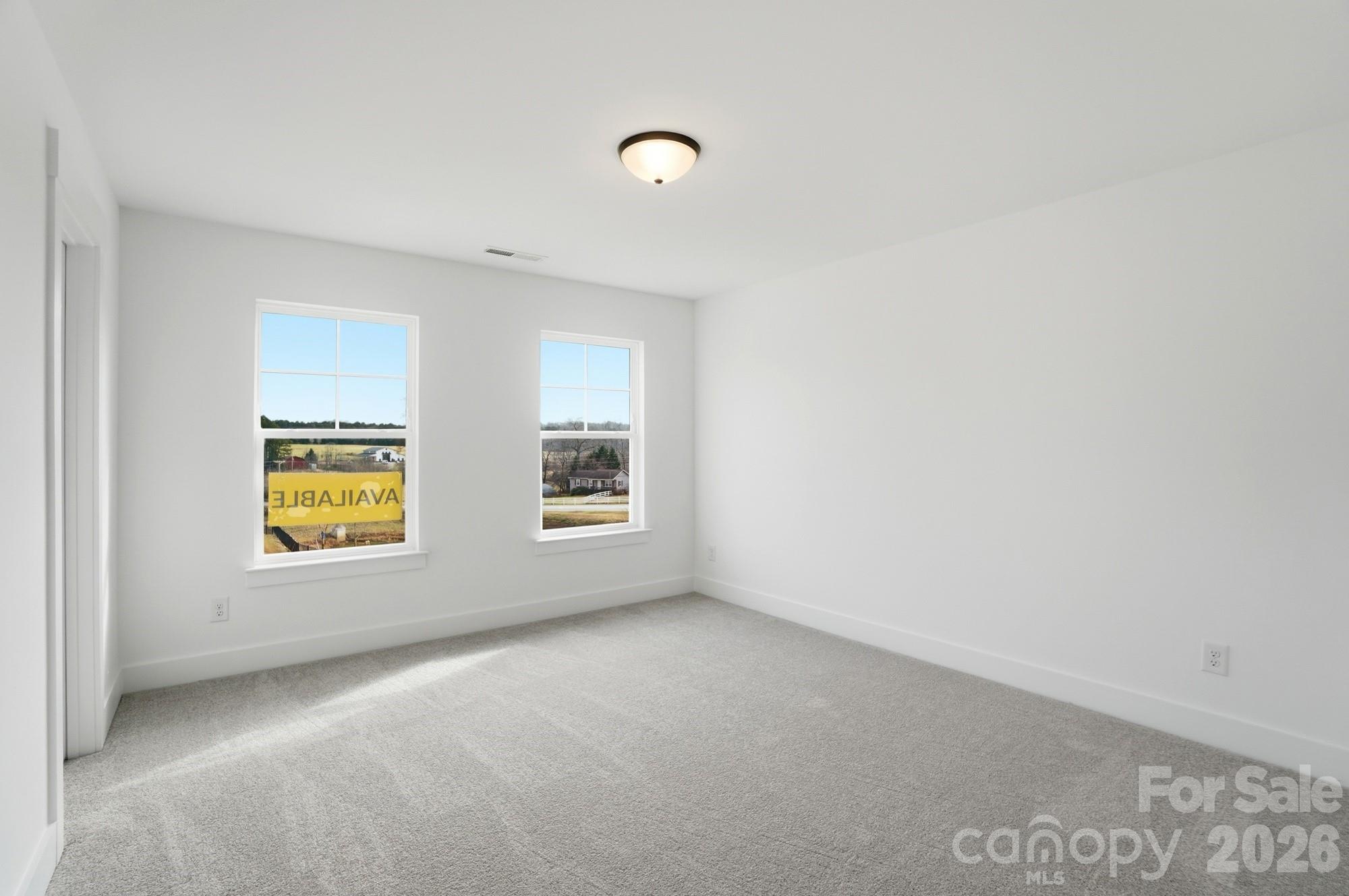 115 Longwood Road Mooresville, NC 28115 - Photo 38 of 43 an empty room with windows and mirror