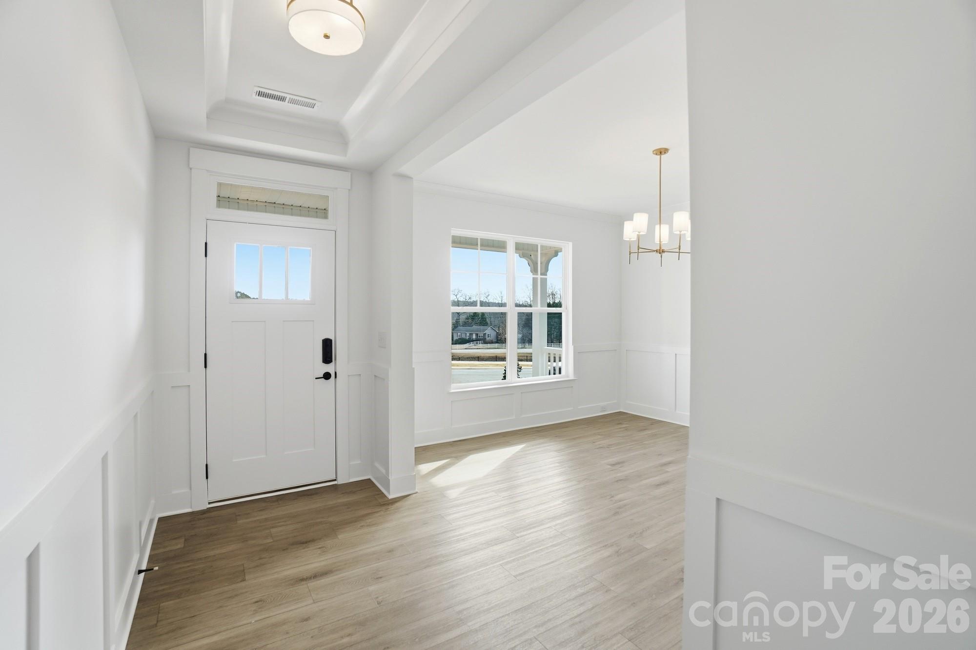 115 Longwood Road Mooresville, NC 28115 - Photo 5 of 43 an empty room with wooden floor and windows
