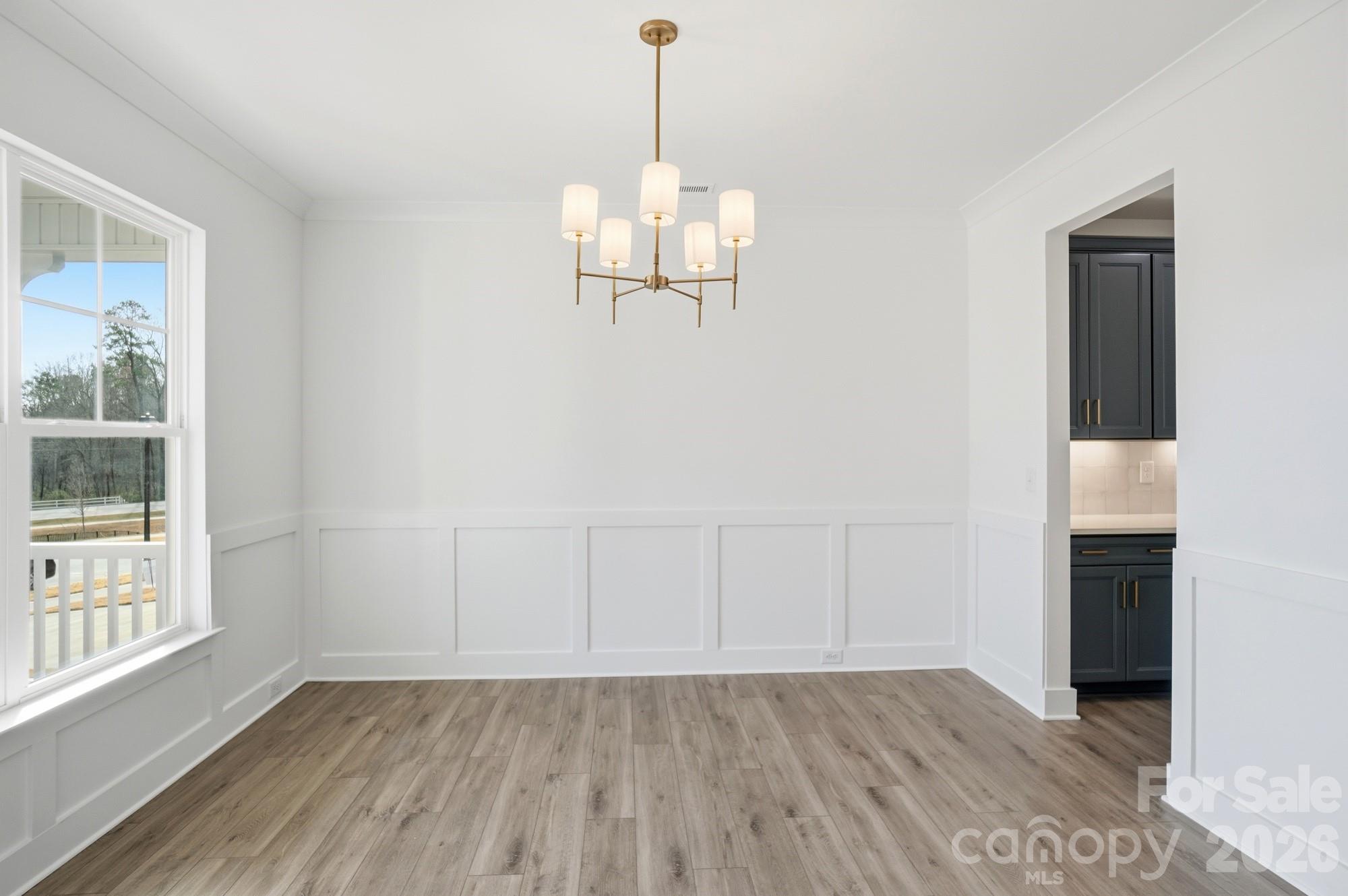 115 Longwood Road Mooresville, NC 28115 - Photo 6 of 43 a view of an empty room with wooden floor and a window