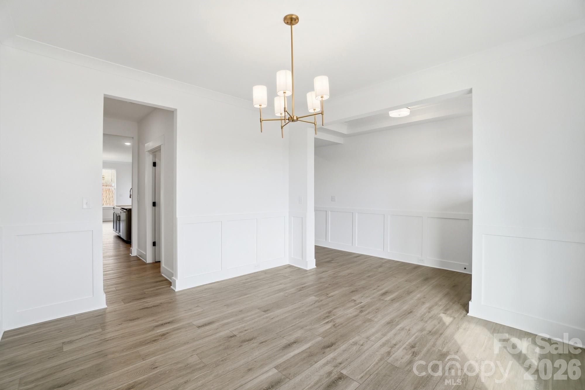 115 Longwood Road Mooresville, NC 28115 - Photo 7 of 43 a view of an empty room with wooden floor