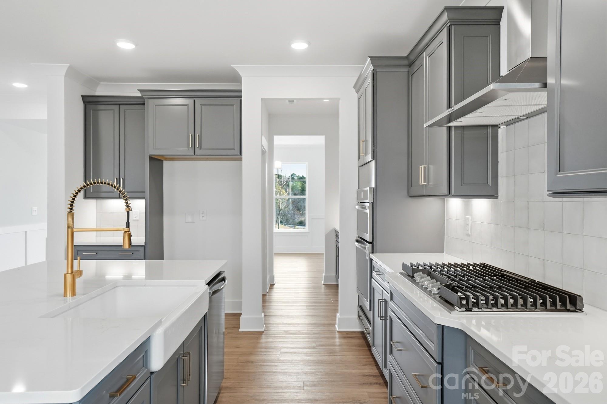 115 Longwood Road Mooresville, NC 28115 - Photo 9 of 43 a kitchen with stainless steel appliances granite countertop a sink a stove and a refrigerator