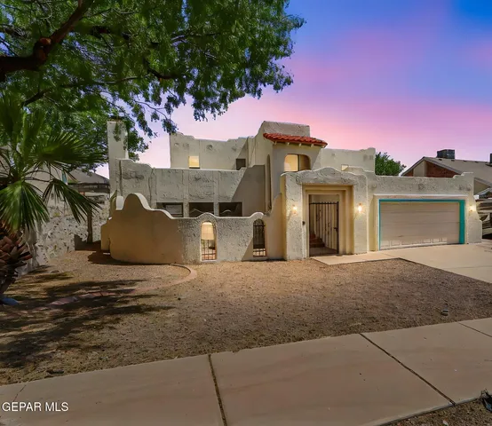 a living room with furniture large windows and wooden floor