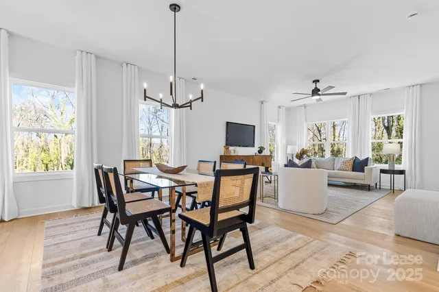 a view of a dining room with furniture window and wooden floor