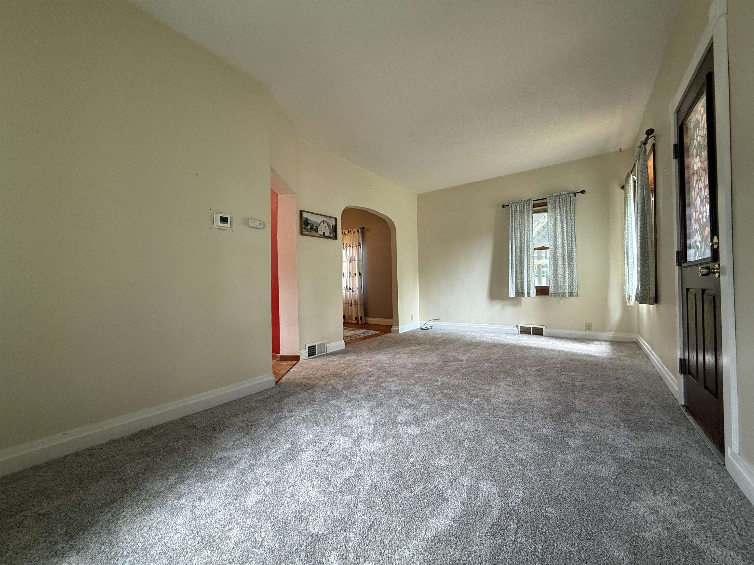 809 16th Street North Virginia, MN 55792 - Photo 14 of 44 Unfurnished room with arched walkways and carpet flooring