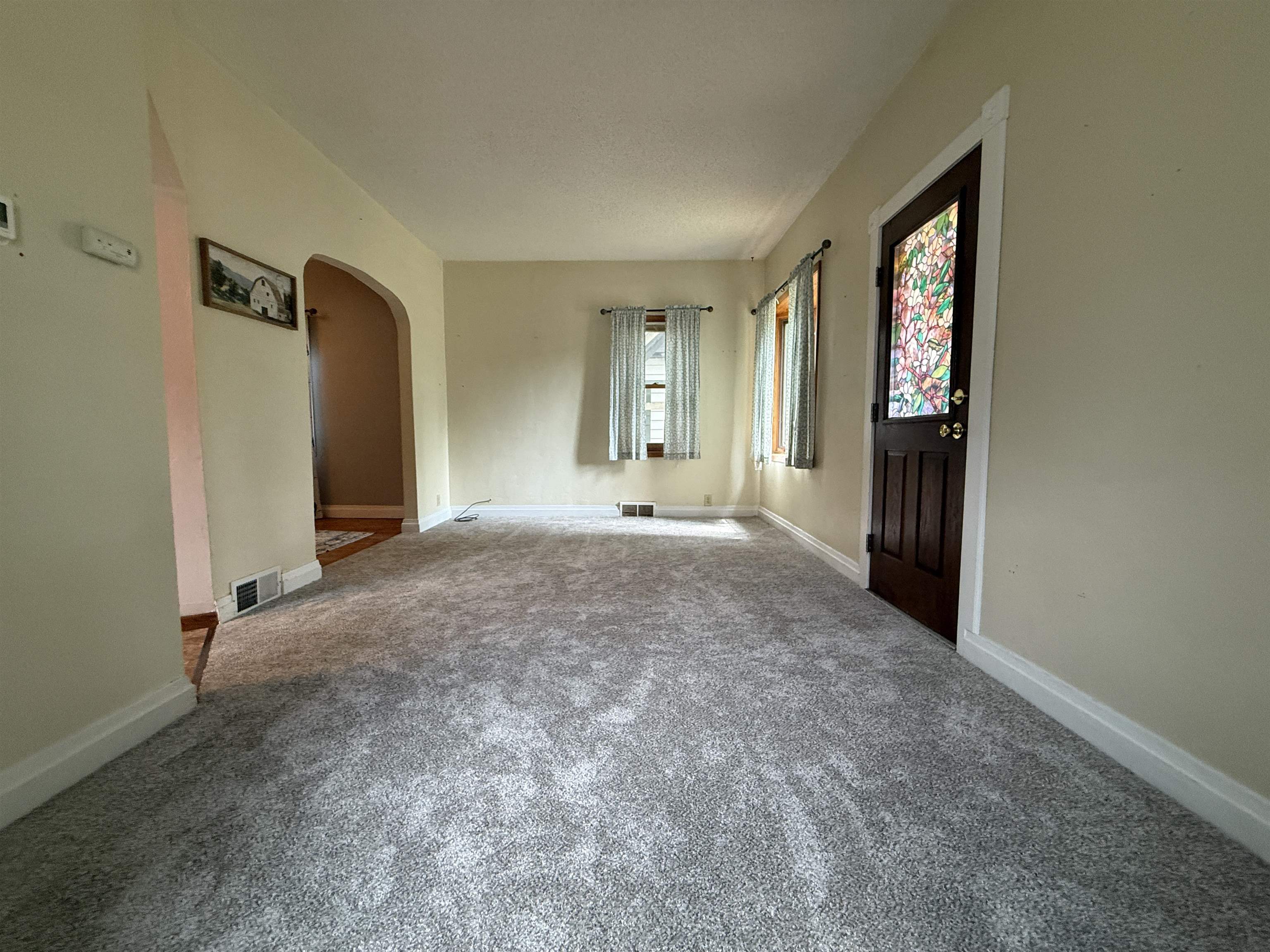 809 16th Street North Virginia, MN 55792 - Photo 15 of 44 Carpeted entrance foyer featuring baseboards and arched walkways