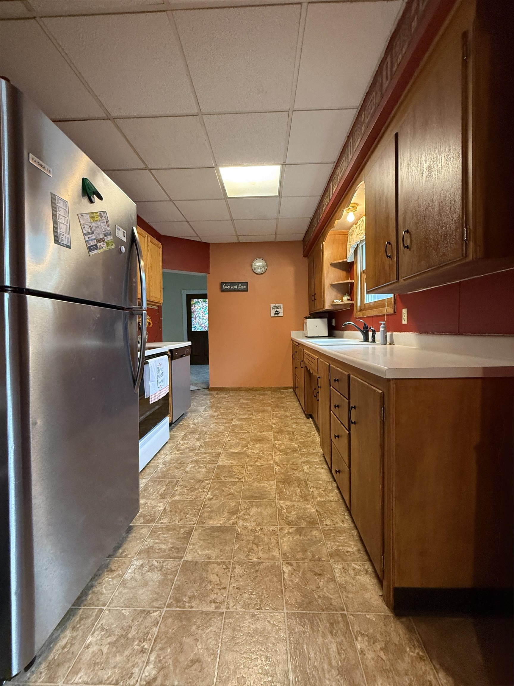 809 16th Street North Virginia, MN 55792 - Photo 21 of 44 Kitchen featuring appliances with stainless steel finishes, a paneled ceiling, open shelves, and light countertops