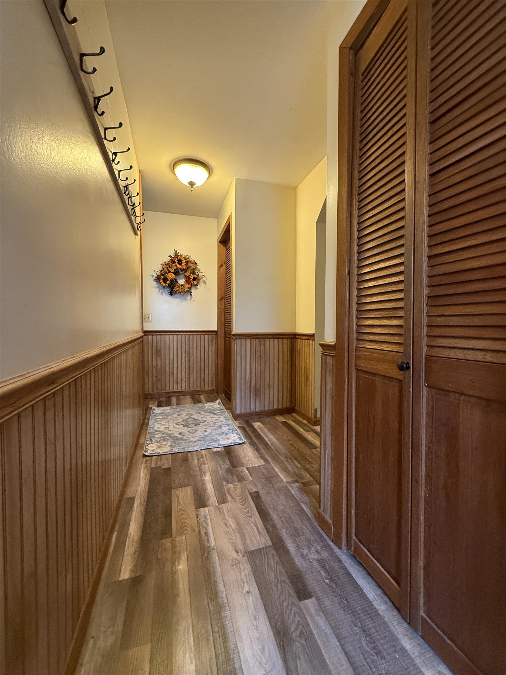 809 16th Street North Virginia, MN 55792 - Photo 23 of 44 Corridor with dark wood-style floors and a wainscoted wall