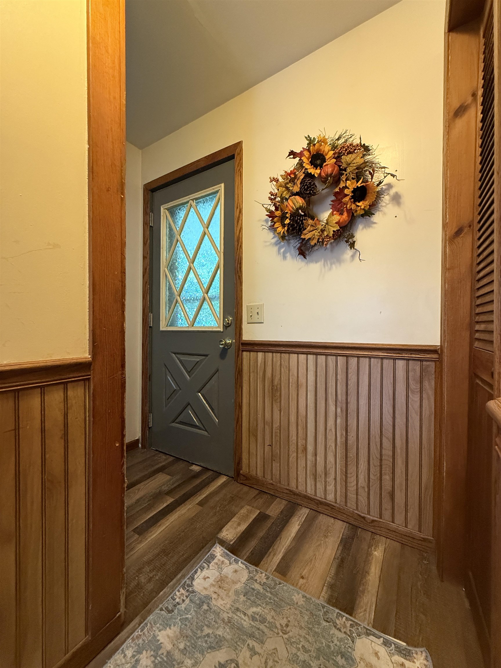 809 16th Street North Virginia, MN 55792 - Photo 24 of 44 Doorway to outside with a wainscoted wall, wood finished floors, and wood walls
