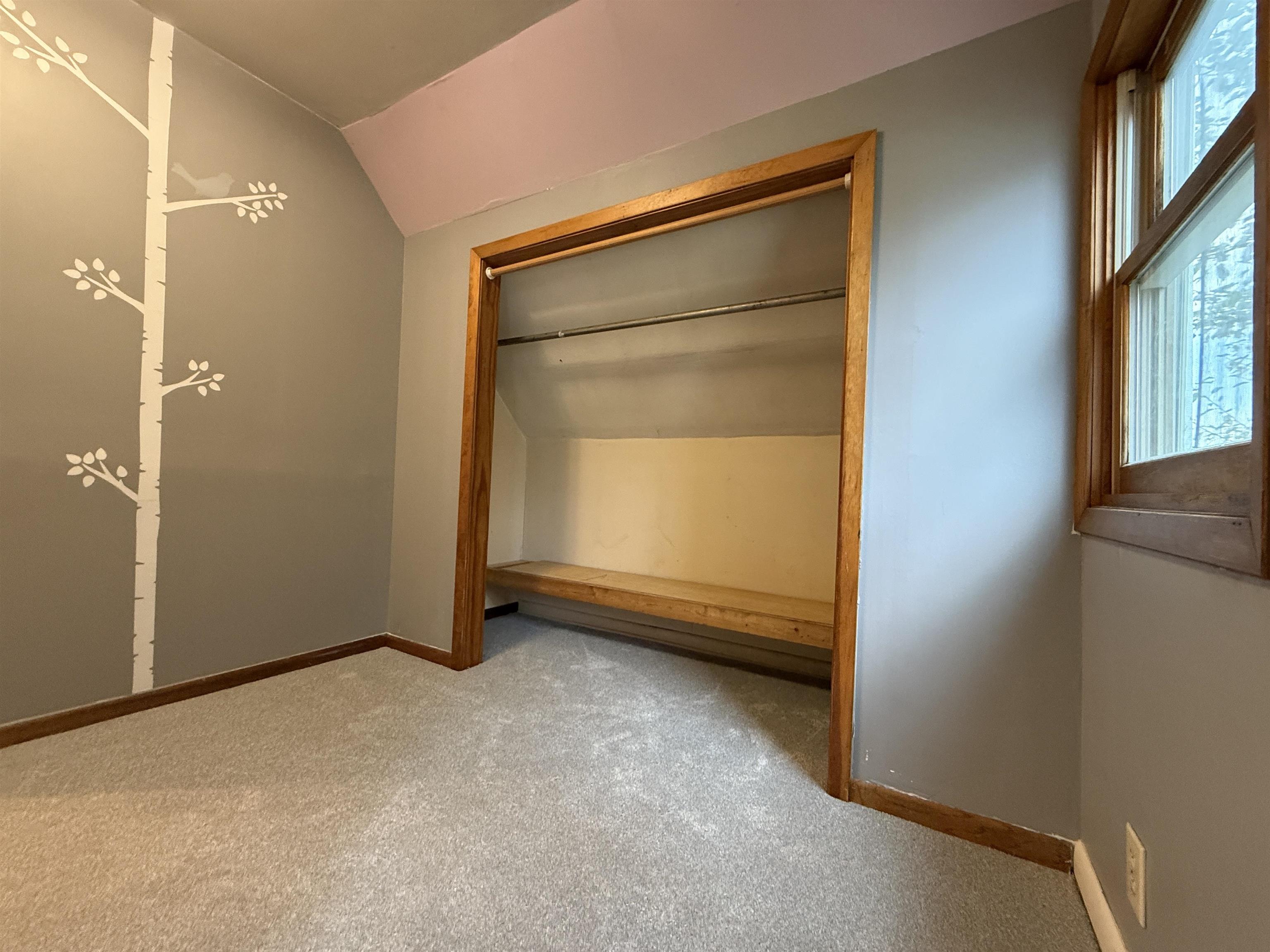 809 16th Street North Virginia, MN 55792 - Photo 26 of 44 Unfurnished bedroom with lofted ceiling and carpet flooring
