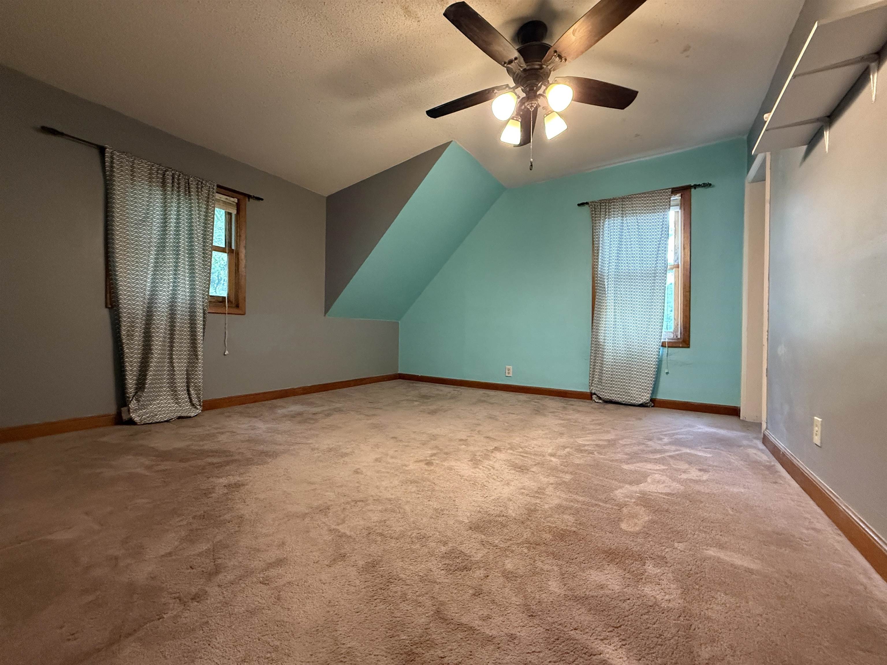 809 16th Street North Virginia, MN 55792 - Photo 32 of 44 Bonus room featuring carpet, a ceiling fan, and a textured ceiling